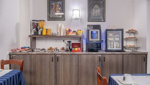 A breakfast bar with coffee machines, a refrigerator, and a variety of food items. - Hôtel Luxor (Issy-les-Moulineaux)