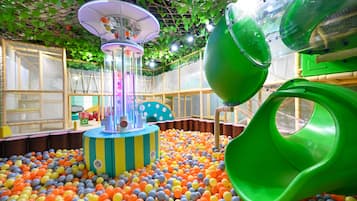 Kids can play and climb in the enclosed play area with a ball pit, slide, and play structure.