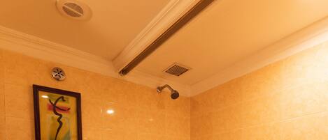 A bathroom with a toilet, bathtub, and shower.
