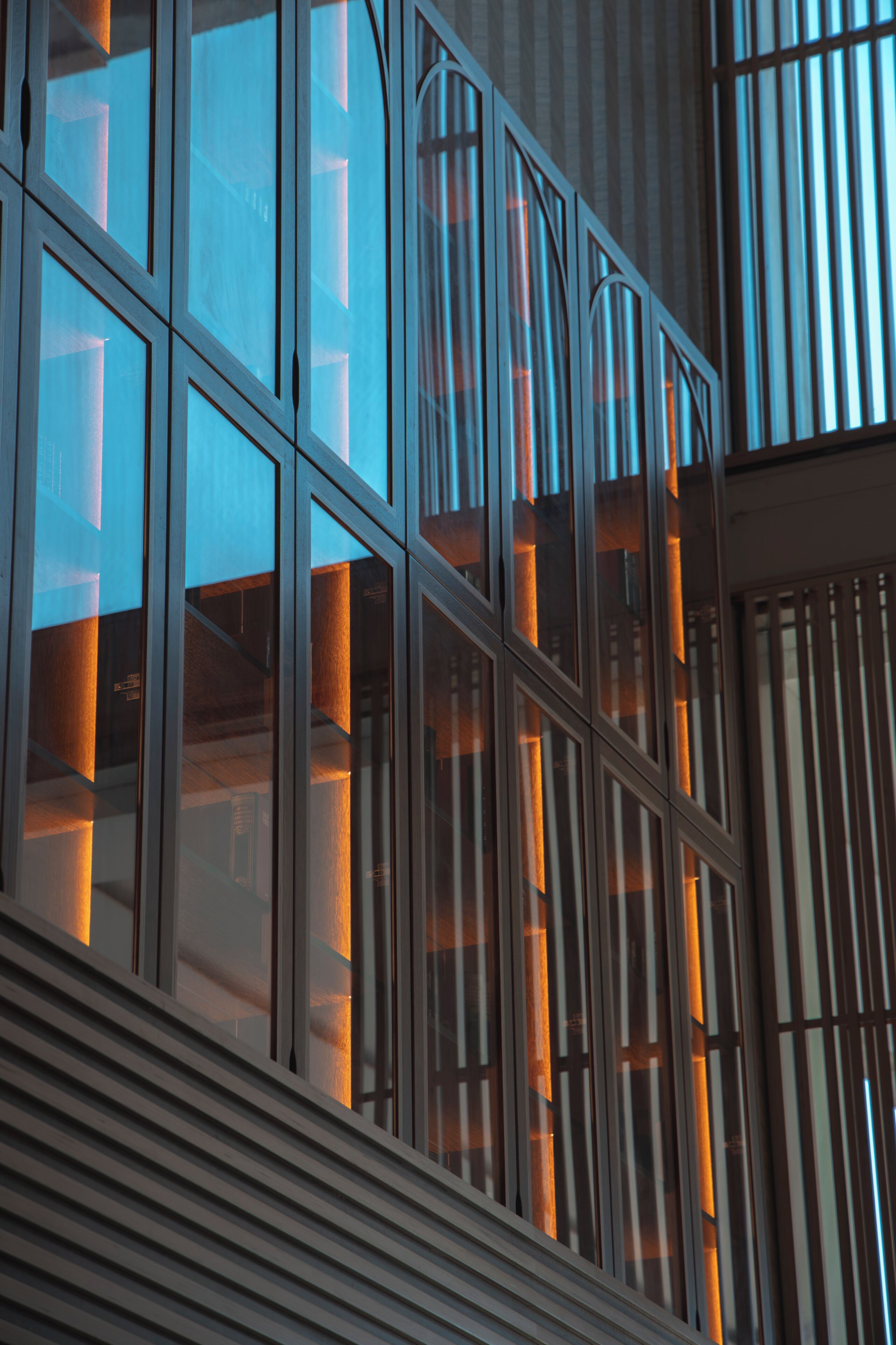 A modern building facade with large windows and vertical structural elements.