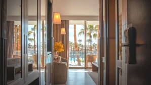 A hotel room with a balcony, a sofa, a chair, and a lamp. - Wine & Books by the sea (Albufeira)
