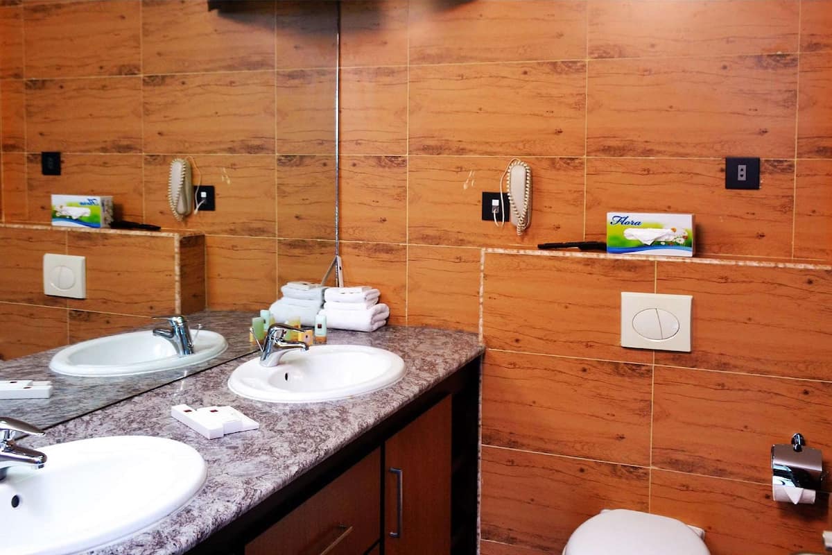 deluxe room, 1 queen bed, non smoking, sea view | in-room safe, desk, iron/ironing board, free cots/infant beds