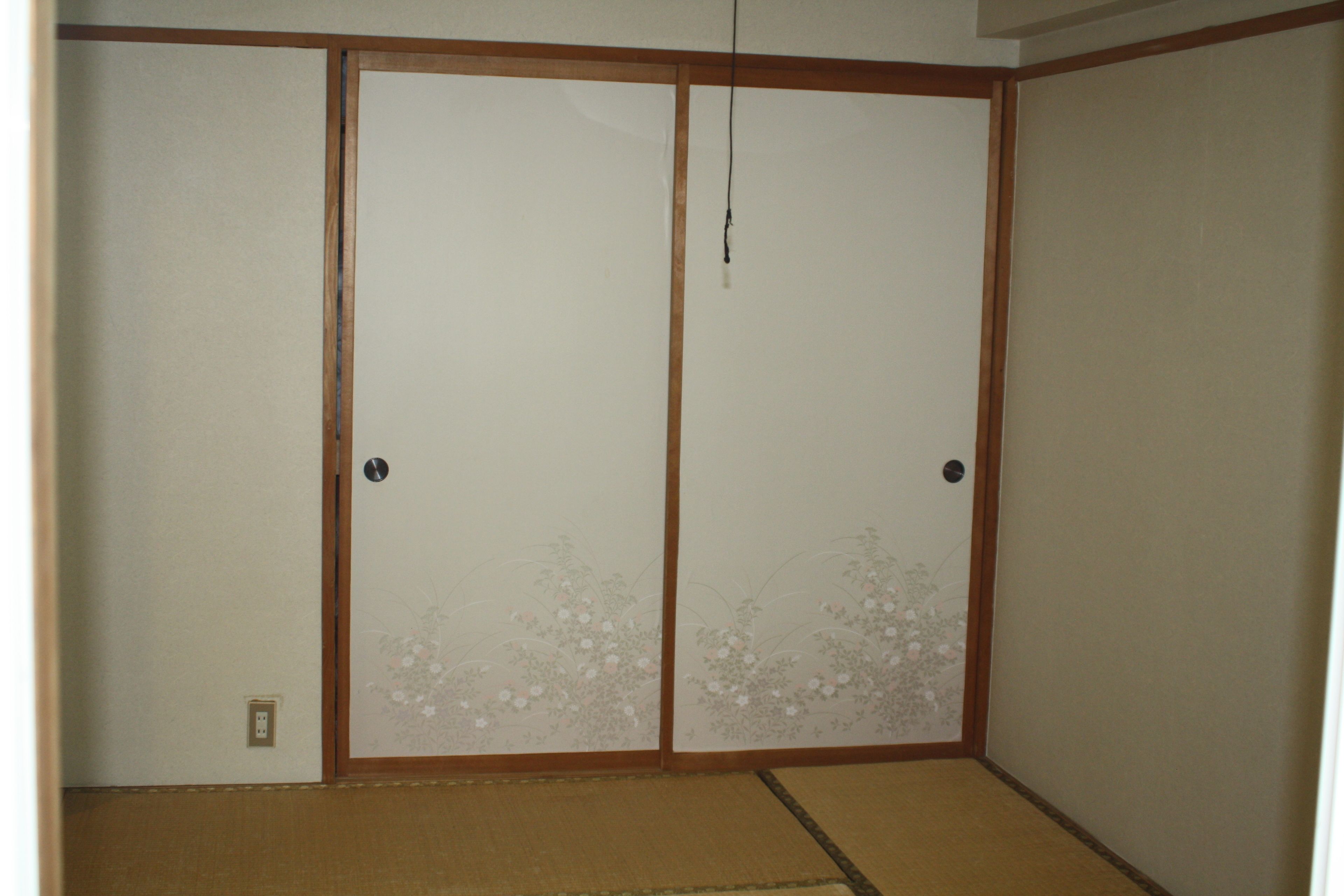A traditional Japanese room with tatami flooring and shoji screens.