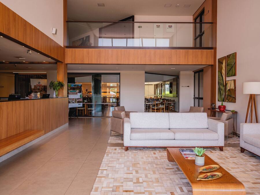 A spacious living area with a sofa, coffee table, and a view of the kitchen and dining area.