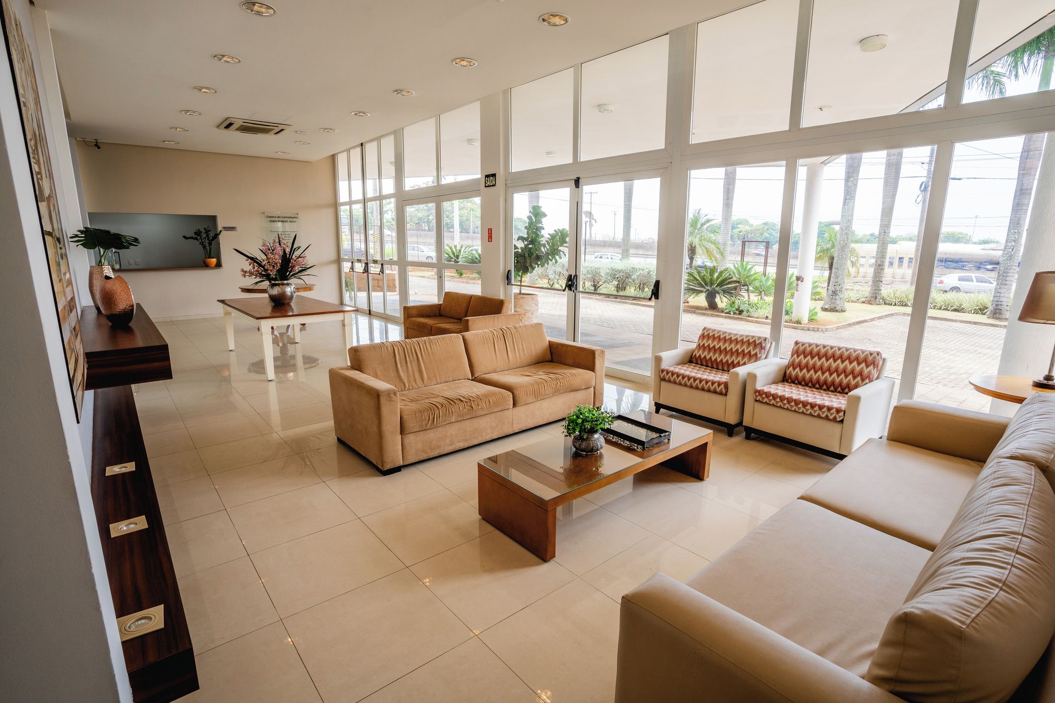 A spacious living area with a sofa set, a coffee table, and a dining table.