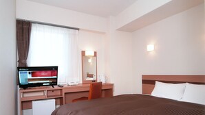 A hotel room with a bed, a desk with a computer, a chair, a small fridge, a mirror, and a window with curtains. - Hotel Promote Hakodate (Hakodate)