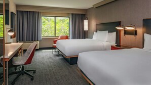 A hotel room with two beds, a desk, a chair, and a large window with curtains. - Courtyard Oneonta (Oneonta)