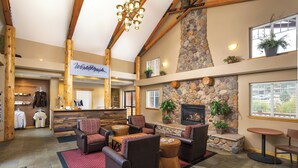 A lobby with a stone fireplace, seating area, and a reception desk. - WorldMark Estes Park (Estes Park)
