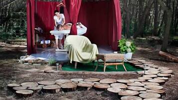 Relax in a serene forest setting with a cozy dining area and natural surroundings.