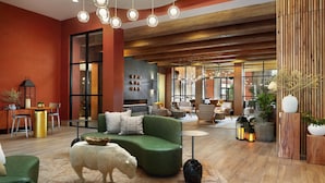 A modern interior with a green sofa, a white sheep sculpture, and a wooden ceiling. - Red Cliffs Lodge Zion, A Tribute Portfolio Hotel - Marriott Bonvoy (Springdale)