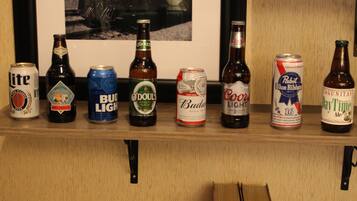 A shelf with various beer cans and bottles.