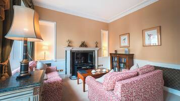 A living room with a fireplace, a television, and a bookshelf.