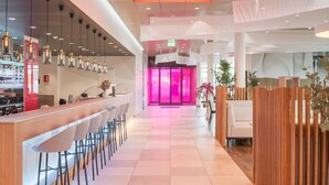 A modern hotel lobby with a bar area, seating, and a reception desk. - Prize by Radisson, Zurich Affoltern am Albis (Affoltern am Albis)
