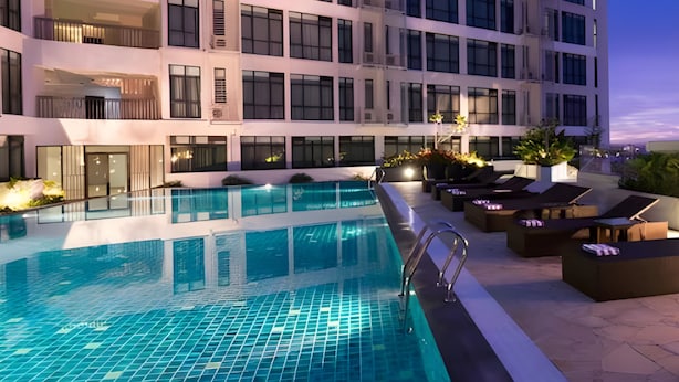 A modern hotel with a rooftop pool, multiple balconies, and outdoor seating areas. - Citadines Uplands Kuching (Kuching)