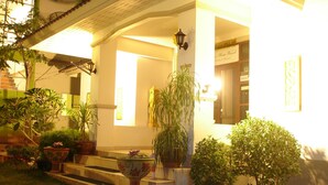 A building with a porch, steps, and potted plants. - Green Home Resort (Surat Thani)