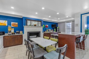 A modern kitchen with a white countertop, wooden cabinets, and a built-in microwave.