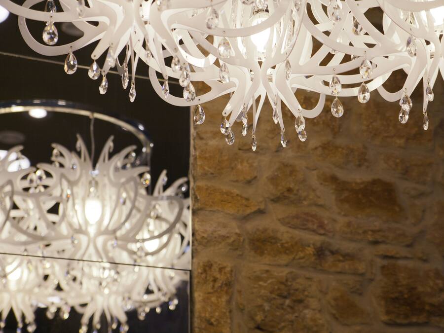 A chandelier with multiple light fixtures and hanging crystals.