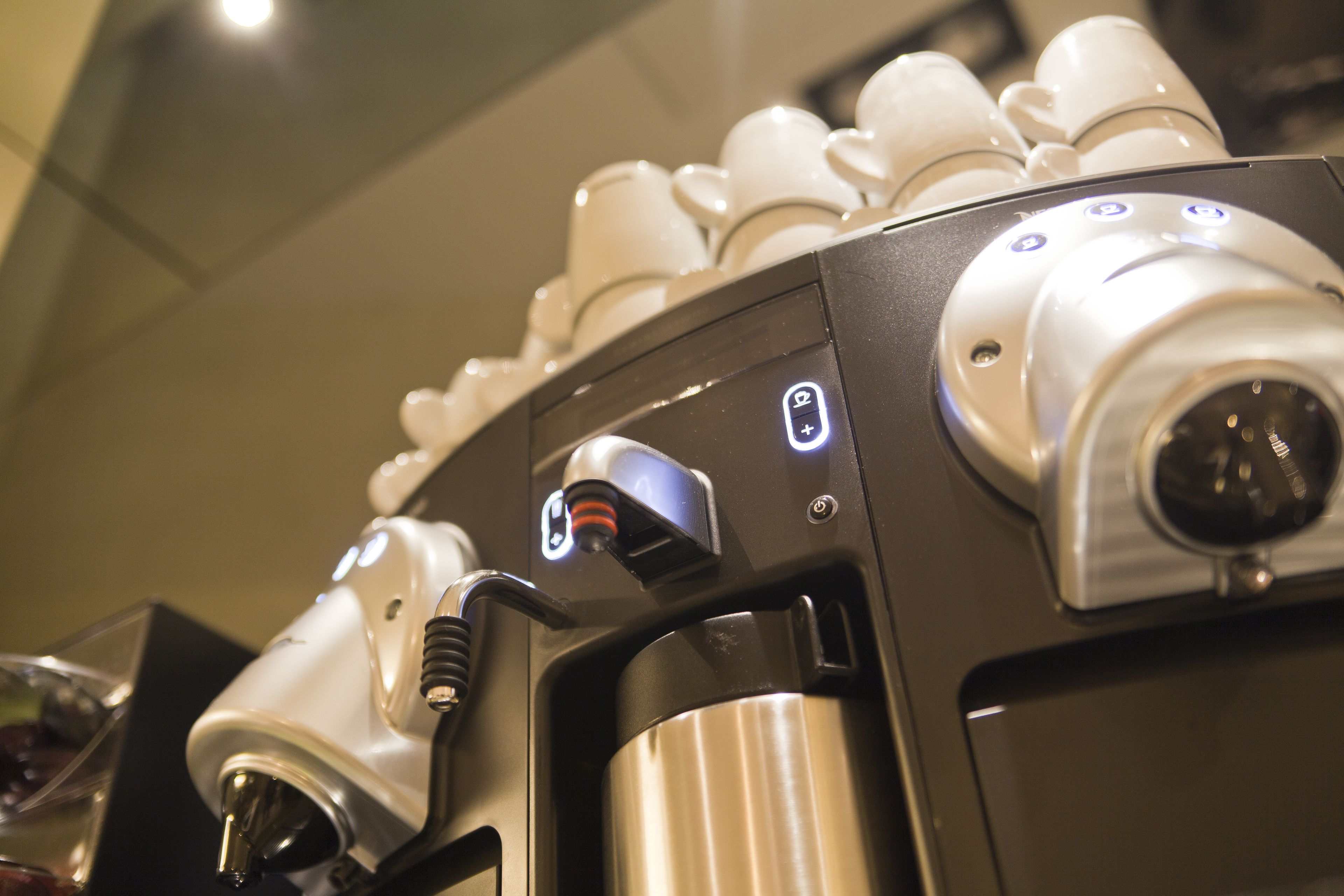A coffee machine with multiple buttons and a steam wand.