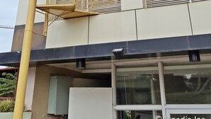 A multi-story building with a spiral staircase and balconies. - Palawan Palm Suites (Puerto Princesa)
