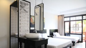 A hotel room with a black vanity, a white sink, two beds, and a large window with curtains. - Thanh Binh II (Da Nang)