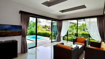 Deluxe Suite Pool Villa | Living area | 32-inch LCD TV with satellite channels, TV