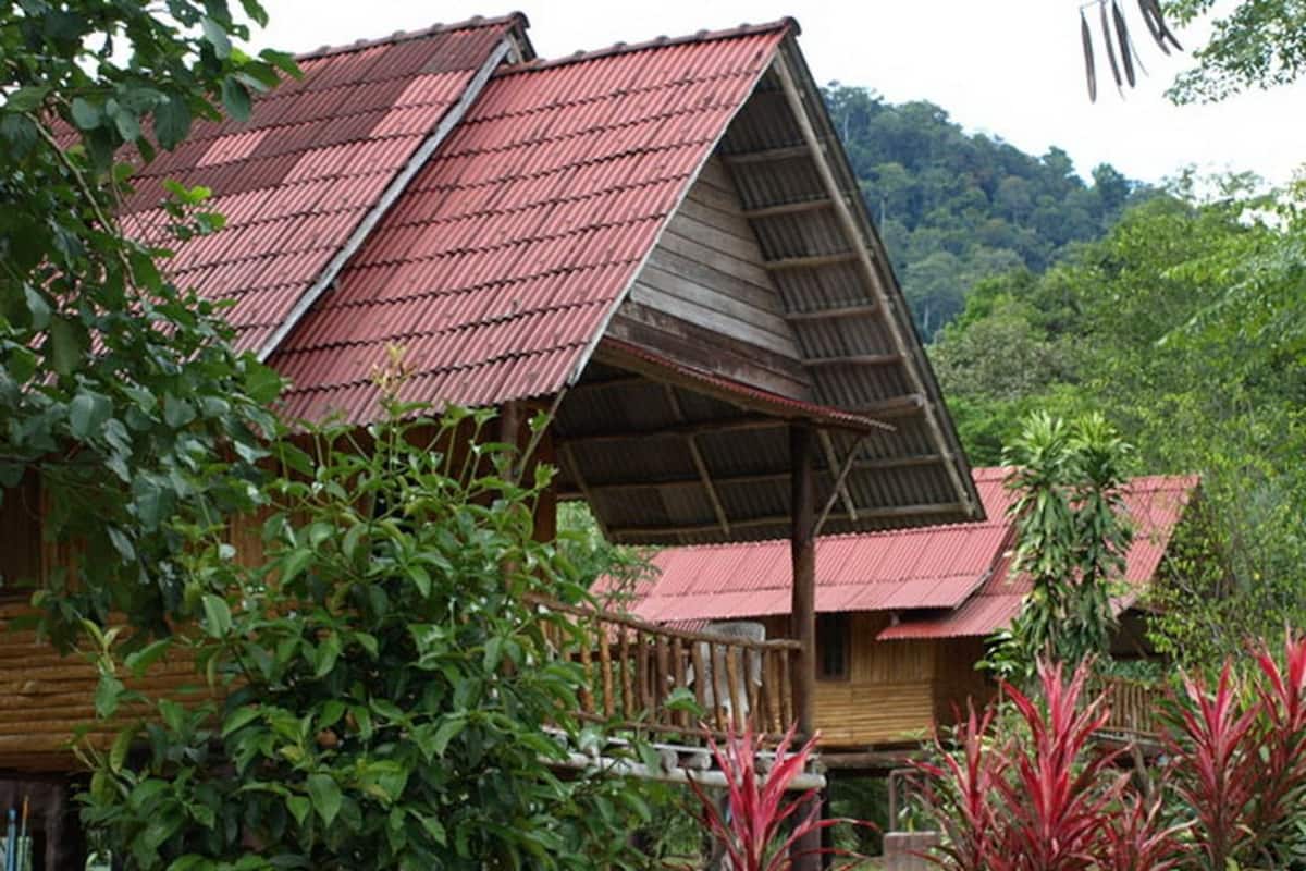 A wooden cabin with a sloped roof and a porch.