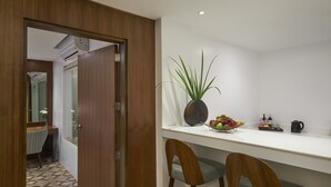 A modern kitchen with a white countertop, a potted plant, and a fruit bowl. - Mövenpick Resort & Spa Boracay (Boracay Island)
