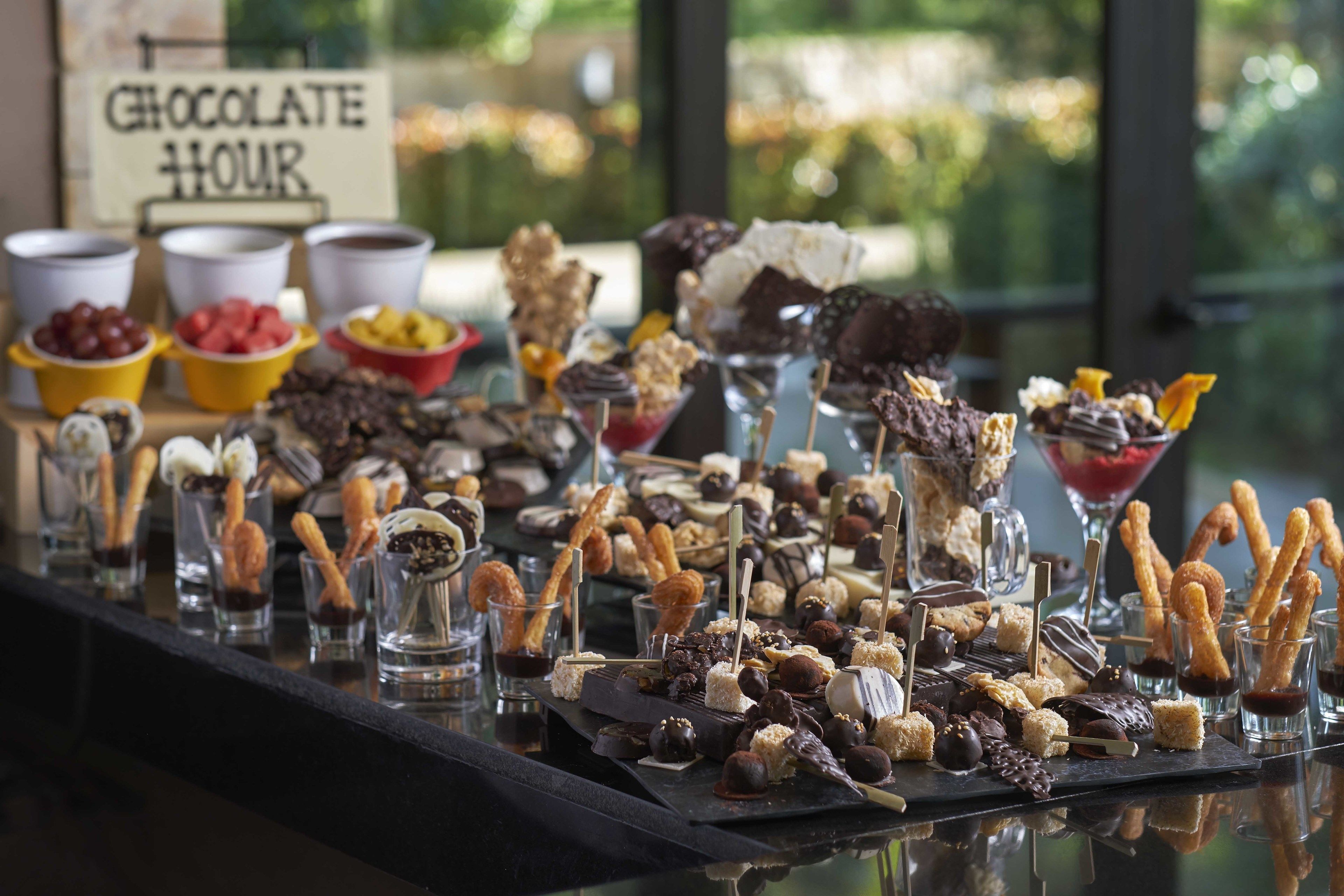 A chocolate hour buffet with various desserts and snacks.