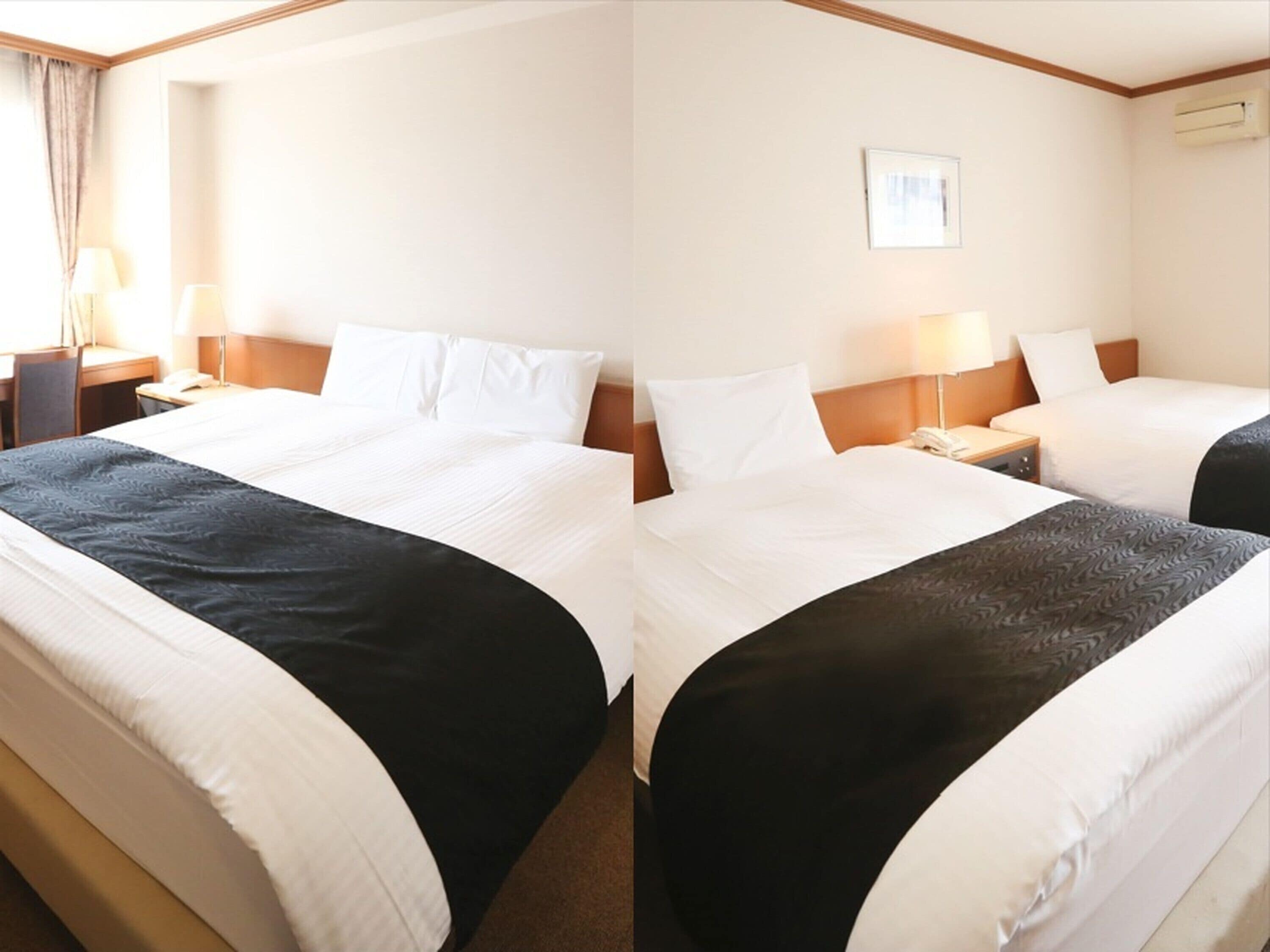A hotel room with a large bed, two bedside tables, a lamp, a picture on the wall, and an air conditioning unit.