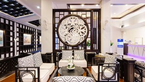 A modern hotel lobby with a traditional decorative screen, seating arrangements, and a reception desk. - Days Inn by Wyndham Patong Beach Phuket (Patong)
