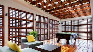 A room with a pool table, sofas, and a wooden ceiling. - Days Inn by Wyndham Patong Beach Phuket (Patong)