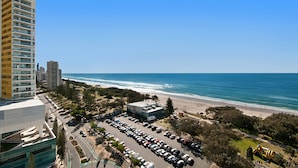 A coastal cityscape with a parking lot, beach, and high-rise buildings. - Voyager Resort (Broadbeach)