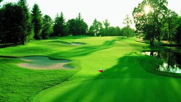 Enjoy a challenging round of golf surrounded by lush greenery and scenic water views.