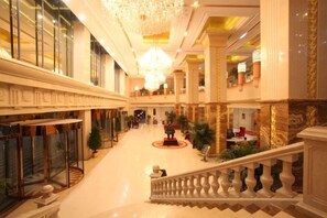 A grand hotel lobby with a central staircase, large chandeliers, and a spacious layout. - Wanfu International Hotel (Xianyang)