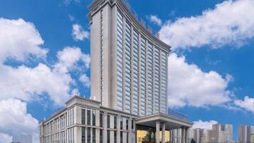 A high-rise hotel with a modern design, featuring a prominent entrance and multiple floors.