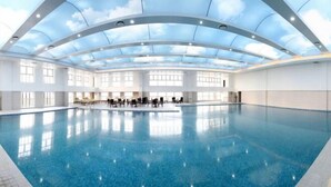 An indoor swimming pool with a clear ceiling and large windows. - Wanfu International Hotel (Xianyang)