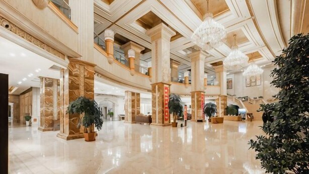 A spacious lobby with high ceilings, chandeliers, and columns. - Wanfu International Hotel (Xianyang)