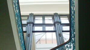 A view from a window with ornate metal railings and a skylight above. - Montevideo Chic Boutique Hostel (Montevideo)