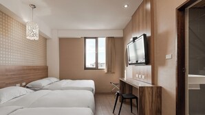 A hotel room with two beds, a desk, a chair, a TV, and a window with curtains. - The Riverside Hotel Hengchun (Hengchun)
