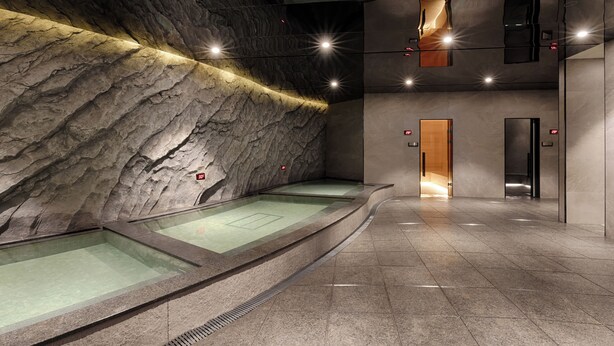 A spa area with a rock wall, a glass-enclosed hot tub, and a corridor leading to an elevator. - Sono Calm Gyeongju (Gyeongju)