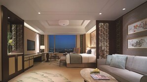 A modern hotel room with a bed, a sofa, a desk, and a TV. - Shangri-La Yangzhou (Yangzhou)