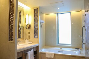 Separate bathtub and shower, designer toiletries, hair dryer, slippers
