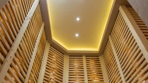 A staircase with wooden railings and a recessed ceiling with lights. - Revesz Hotel (Gyor)