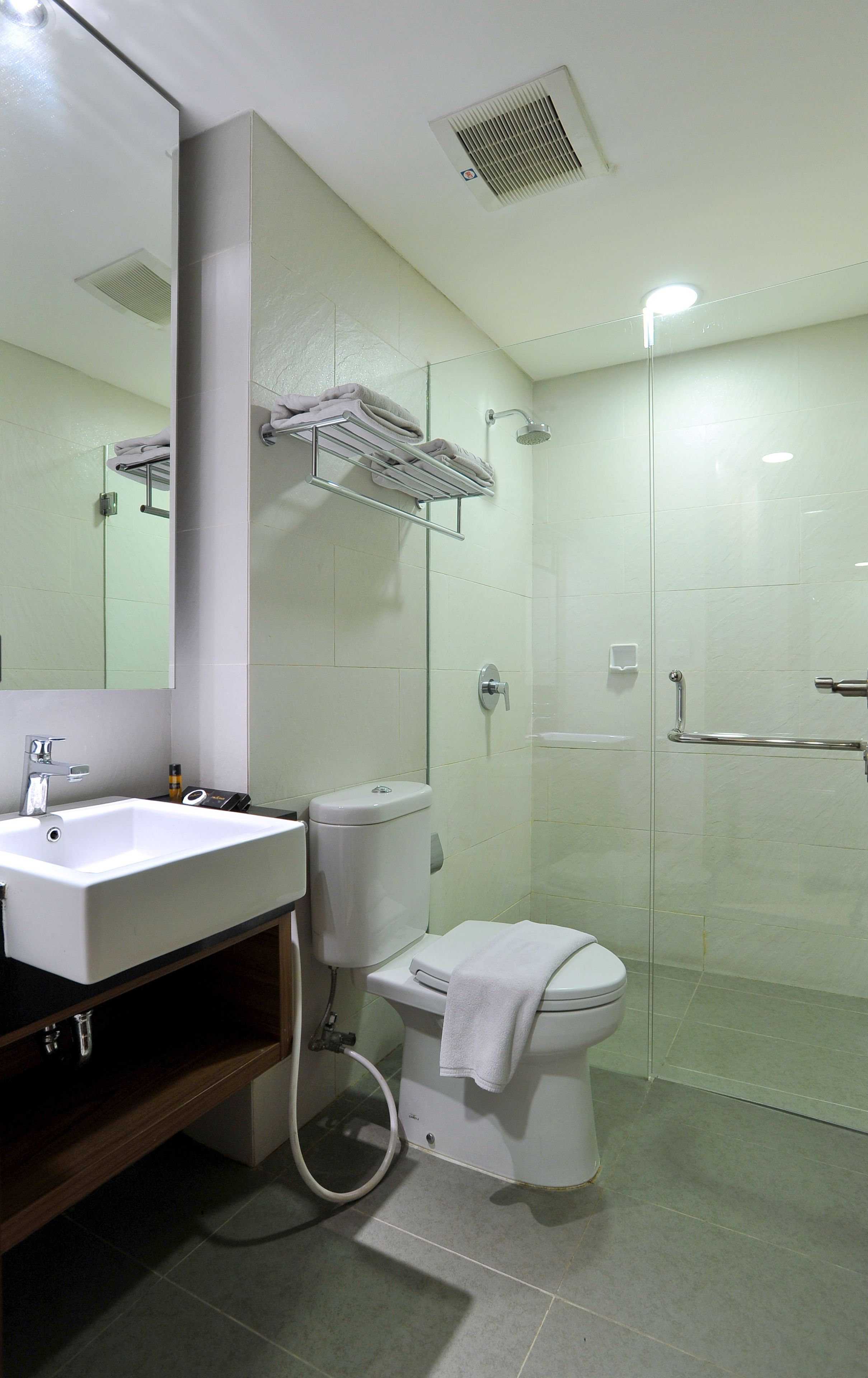 A bathroom with a sink, toilet, and shower.