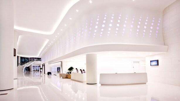 A modern, spacious lobby with a reception desk, seating area, and a staircase leading to upper floors. - Sono Calm Yeosu (Yeosu)