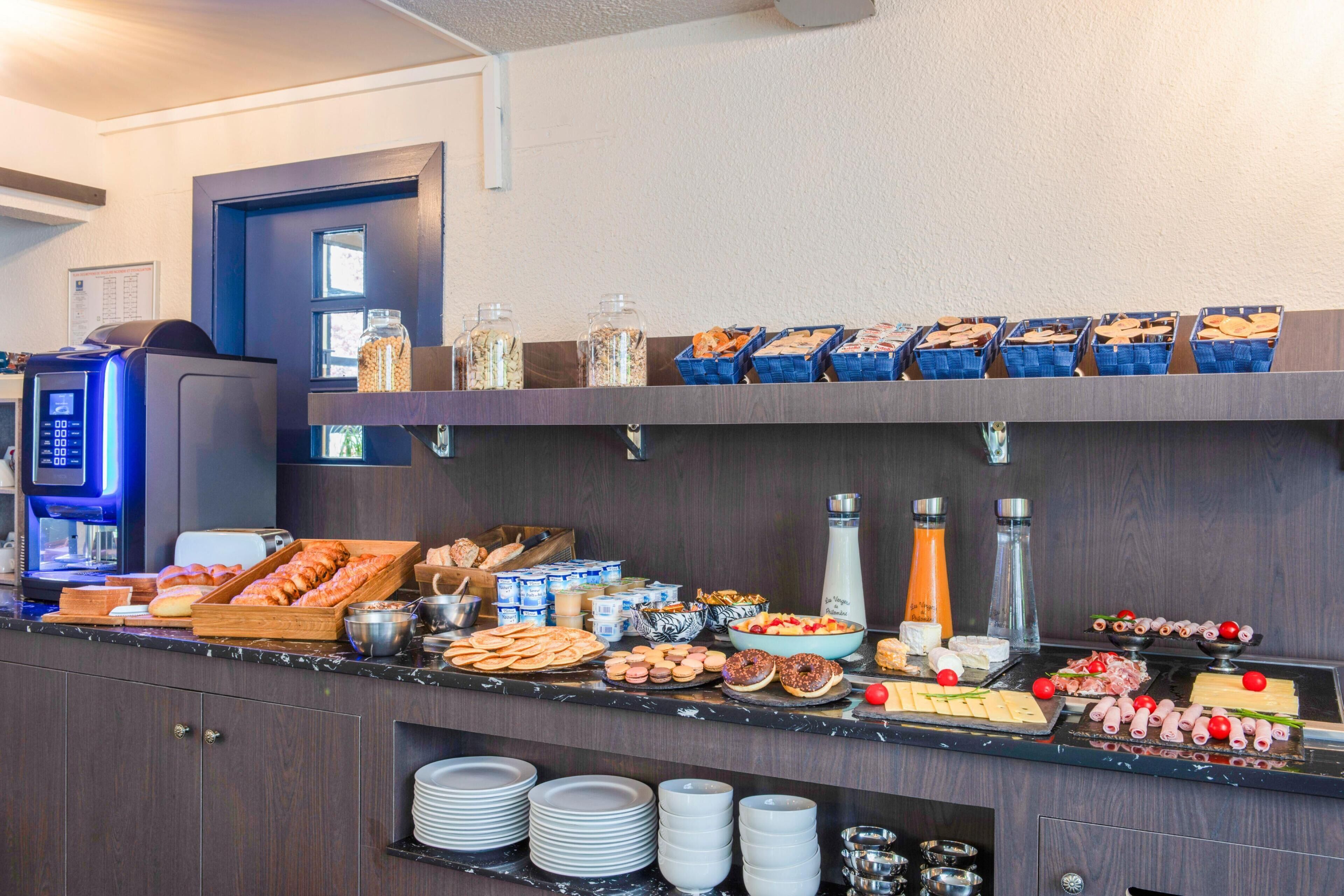 A buffet setup with various food items and beverages.