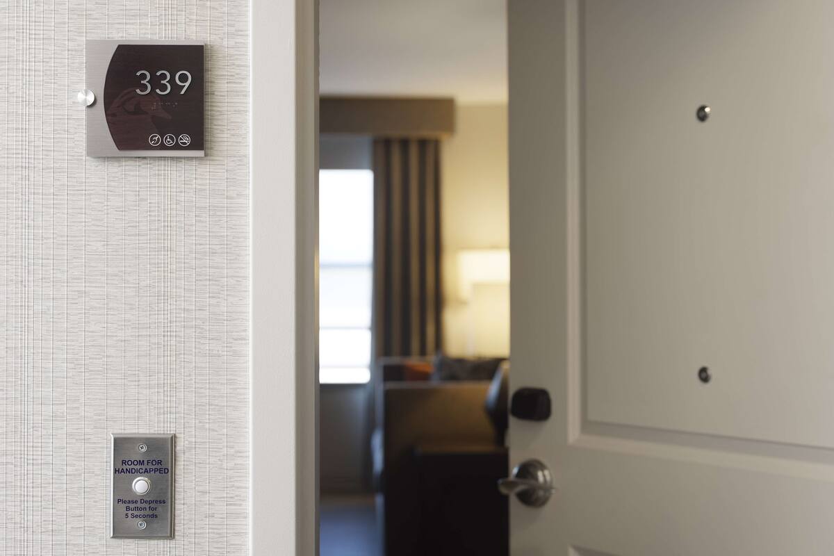 A hotel room door with a sign indicating room number 339 and a button for handicapped access.