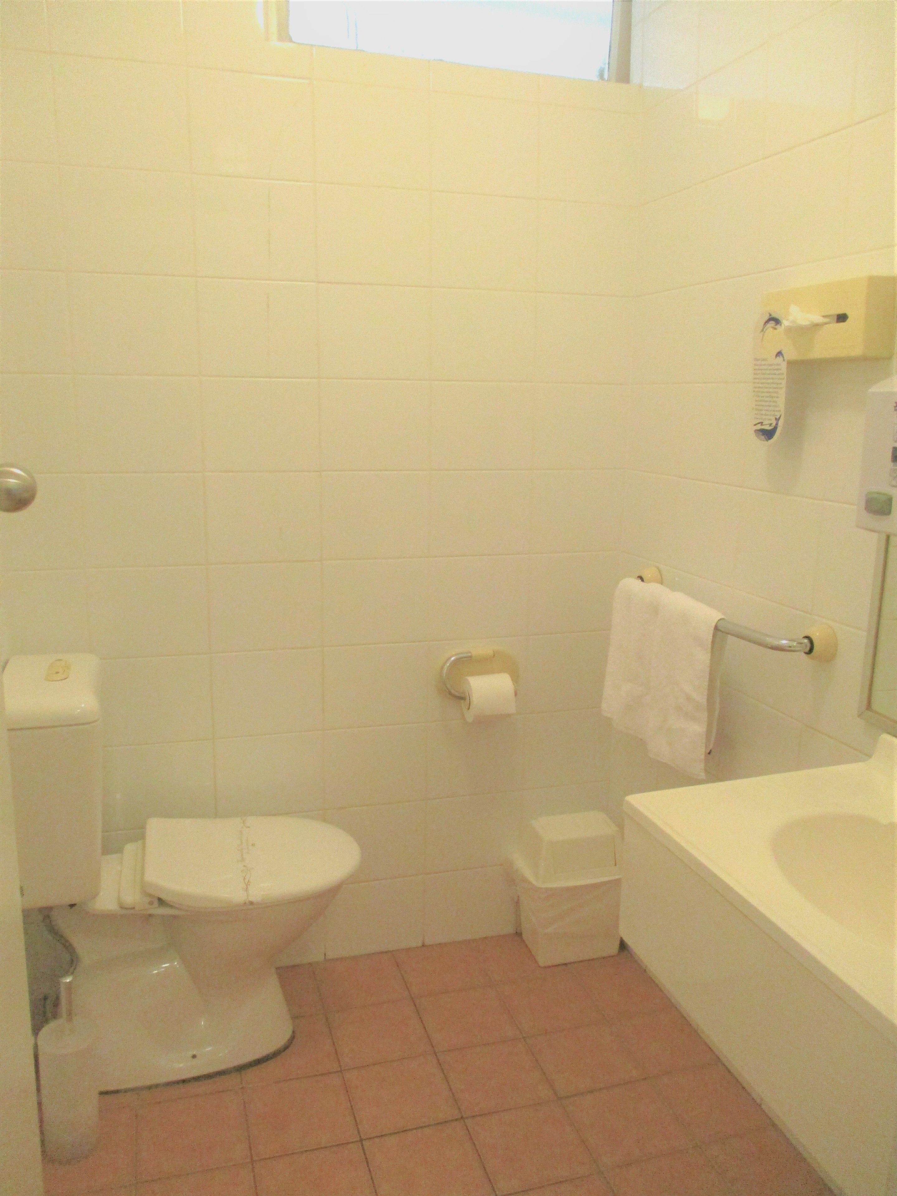 A small, clean bathroom with a toilet, a sink, and a bathtub.