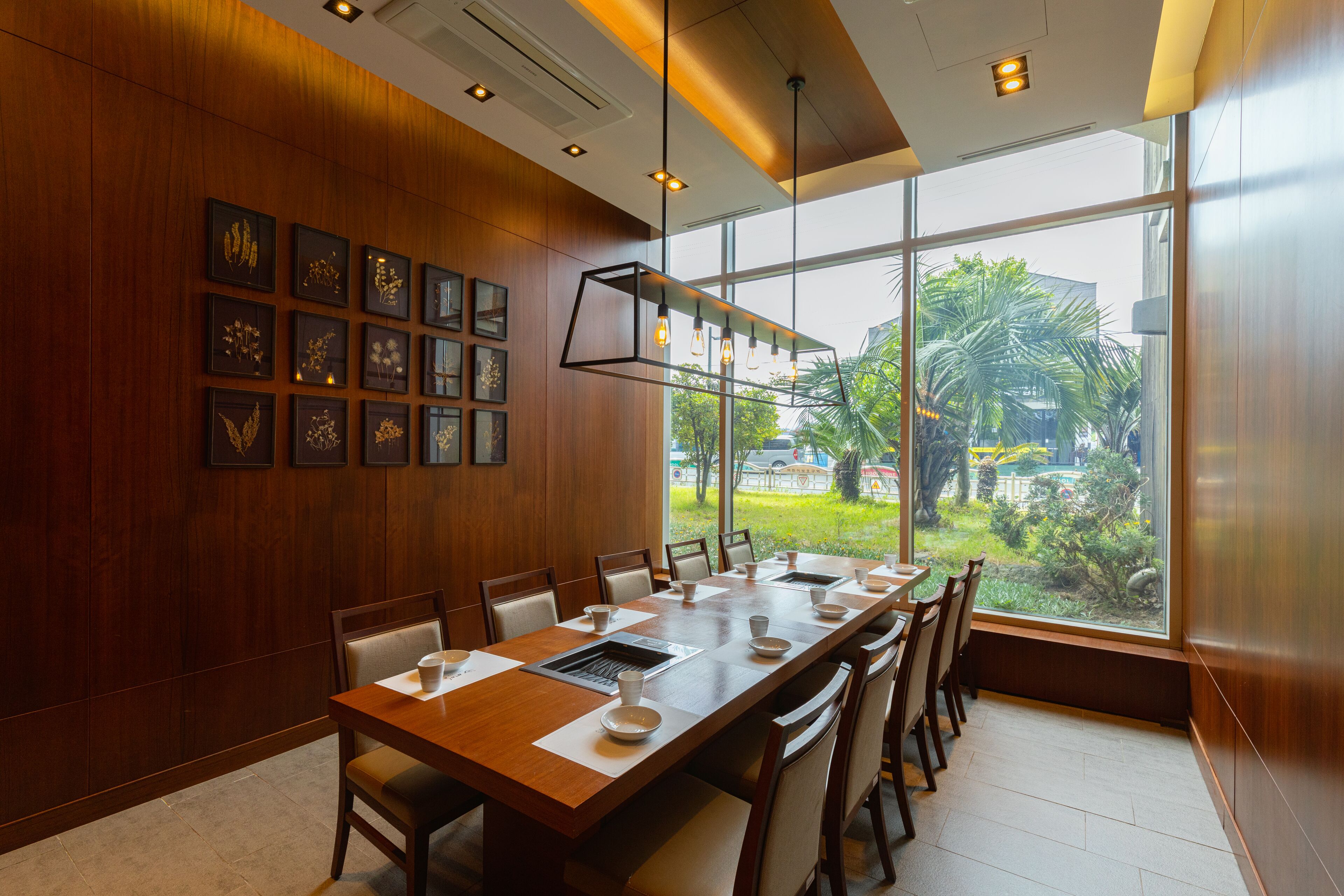 A conference room with a long table, chairs, and framed pictures on the wall.