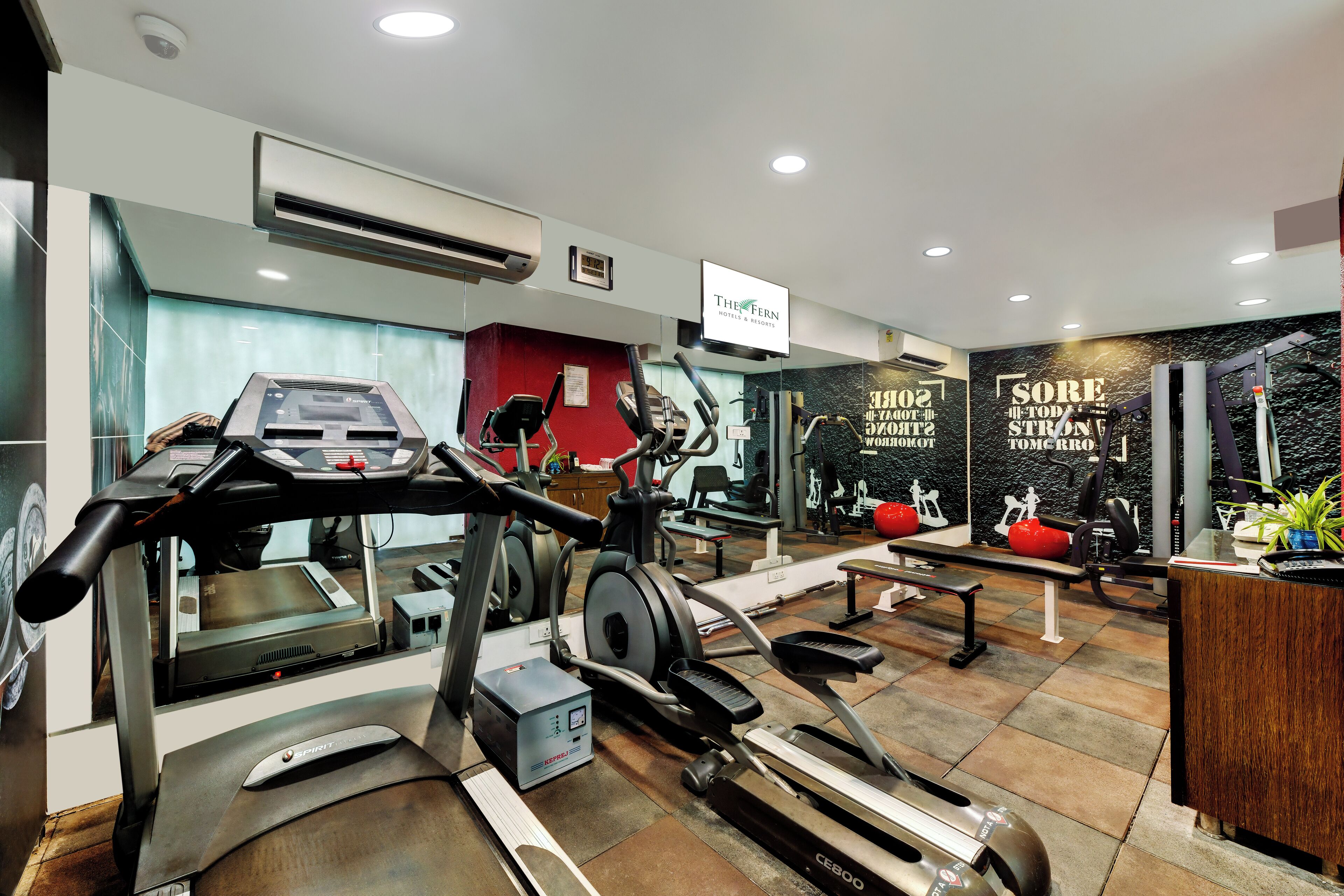 A gym with treadmills, elliptical machines, and weight equipment.
